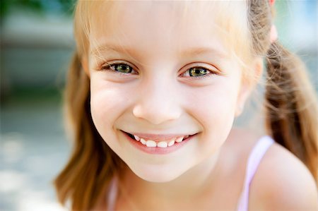 cute little girl smiling in a park close-up Stock Photo - Budget Royalty-Free & Subscription, Code: 400-05342069