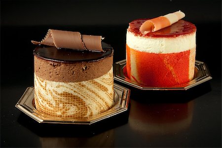 simsearch:400-05173009,k - Tasteful Chocolate Pastry mousse and Fruit Pastry made of passion fruit isolated on black background Stock Photo - Budget Royalty-Free & Subscription, Code: 400-05342364