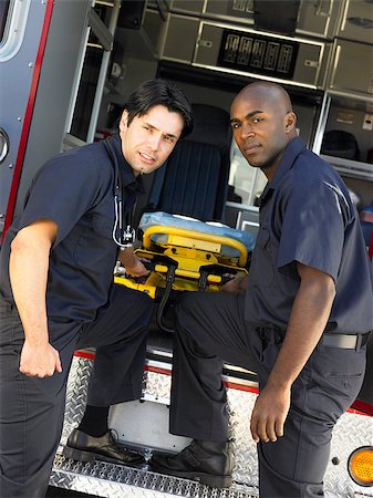 simsearch:400-05343071,k - Two paramedics cheerfully removing empty gurney from ambulance Stock Photo - Budget Royalty-Free & Subscription, Code: 400-05343084