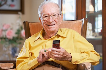 phone one person adult smile elderly - Senior man text messaging Stock Photo - Budget Royalty-Free & Subscription, Code: 400-05343094