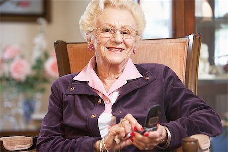 phone one person adult smile elderly - Senior woman text messaging Stock Photo - Budget Royalty-Free & Subscription, Code: 400-05343097