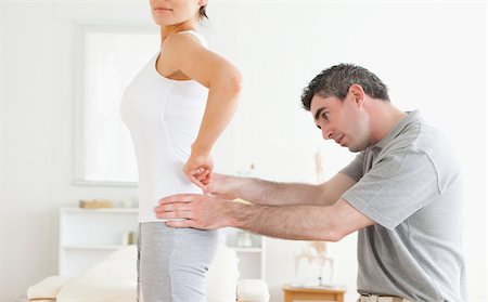 doctor and patient adult shoulder - Chiropractor examining a cute woman's back in a room Stock Photo - Budget Royalty-Free & Subscription, Code: 400-05357132