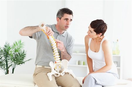 Brunette woman looking at a model-spine listening to an explanation Stock Photo - Budget Royalty-Free & Subscription, Code: 400-05357144