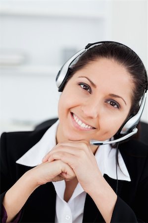 simsearch:400-05287143,k - A smiling operator sitting with a headset in her office Stock Photo - Budget Royalty-Free & Subscription, Code: 400-05357527