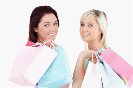simsearch:400-04904785,k - Cute young women with shopping bags in a studio Stock Photo - Budget Royalty-Free & Subscription, Code: 400-05357799