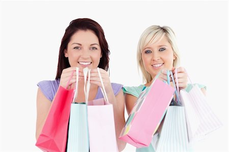 simsearch:400-04904785,k - Smiling young women with shopping bags in a studio Stock Photo - Budget Royalty-Free & Subscription, Code: 400-05357800