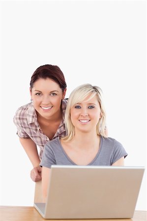simsearch:400-05357982,k - Portrait of smiling women with a laptop in a studio Stock Photo - Budget Royalty-Free & Subscription, Code: 400-05358789