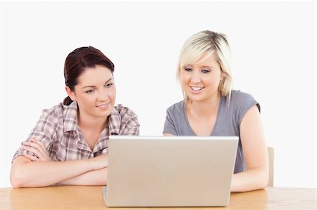 simsearch:400-05357982,k - Two gorgeous women learning with a notebook and some books Stock Photo - Budget Royalty-Free & Subscription, Code: 400-05358780