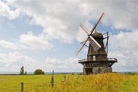 An old windmill is shown in a rural area. There are no people viewable. Horizontally framed shot. Stock Photo - Budget Royalty-Free & Subscription, Code: 400-05359893