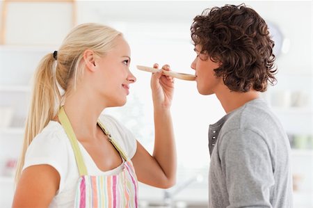 simsearch:400-05740111,k - Blonde woman making her fiance tasting her meal while looking at him Stock Photo - Budget Royalty-Free & Subscription, Code: 400-05350361