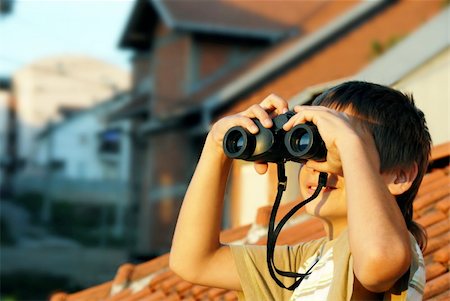 teen boy watching at black binoculars outdoor portrait Stock Photo - Budget Royalty-Free & Subscription, Code: 400-05351014