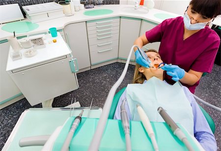 Female dentist working on patient in modern dental surgery Stock Photo - Budget Royalty-Free & Subscription, Code: 400-05352206