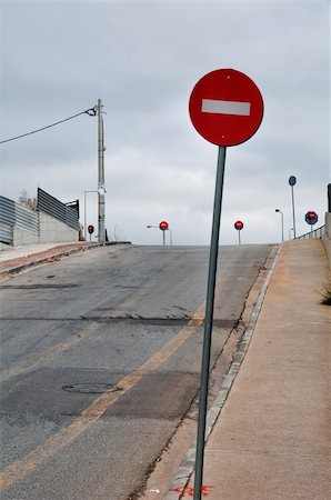 deserted city streets - No entry red signs on sloped side street leading to motorway exit junction. Stock Photo - Budget Royalty-Free & Subscription, Code: 400-05352496