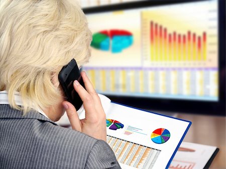 Woman on a phone analyzing financial data and charts . Stock Photo - Budget Royalty-Free & Subscription, Code: 400-05353255