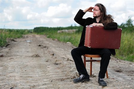 Man with an old suitcase waiting for something on the road Stock Photo - Budget Royalty-Free & Subscription, Code: 400-05367986