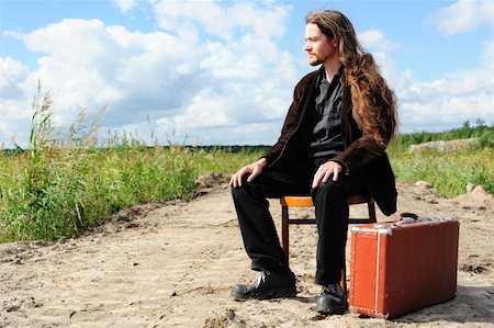 Man with an old suitcase waiting for something on the road Stock Photo - Budget Royalty-Free & Subscription, Code: 400-05367983