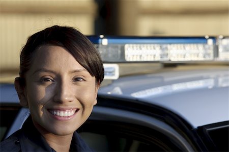 female police officer happy - a happy female police officer standing next to her patrol unit. Photographie de stock - Aubaine LD & Abonnement, Code: 400-05360785
