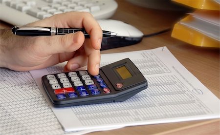 rate - man hand holding pen on calculator buttons in office Stock Photo - Budget Royalty-Free & Subscription, Code: 400-05361580