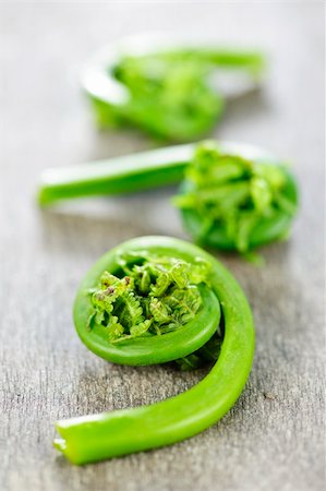 Fresh spring wild fiddleheads close up on wooden board Stock Photo - Budget Royalty-Free & Subscription, Code: 400-05372347