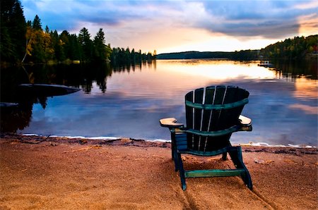 Wooden chair on beach of relaxing lake at sunset Stock Photo - Budget Royalty-Free & Subscription, Code: 400-05372374
