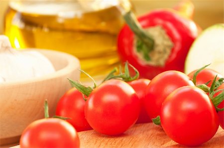simsearch:400-04393672,k - Cherry tomato on a wooden board with vegetables and olive oil in the back Stock Photo - Budget Royalty-Free & Subscription, Code: 400-05384734