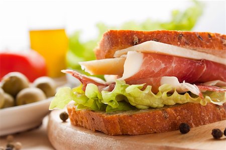 simsearch:400-06207145,k - Prosciutto and cheese sandwich with olives and lettuce. Stock Photo - Budget Royalty-Free & Subscription, Code: 400-05384760