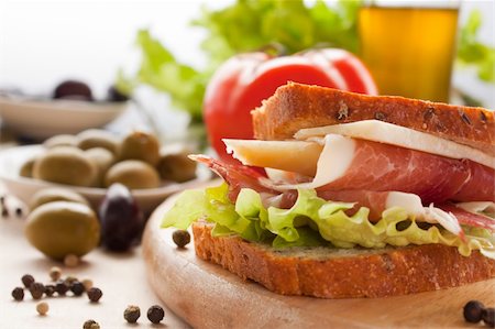 simsearch:400-06207145,k - Prosciutto and cheese sandwich with olives and lettuce. Stock Photo - Budget Royalty-Free & Subscription, Code: 400-05384761