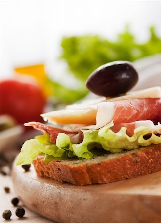 simsearch:400-06207145,k - Prosciutto and cheese sandwich with olives and lettuce. Stock Photo - Budget Royalty-Free & Subscription, Code: 400-05384762