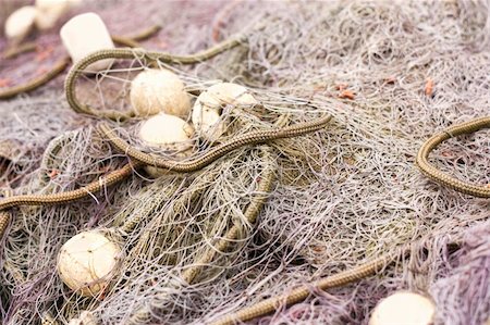 simsearch:6118-08910527,k - Freshly used wet fishing net with corks lying on the boat floor. Photographie de stock - Aubaine LD & Abonnement, Code: 400-05384814
