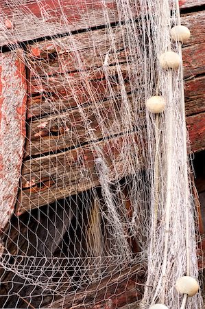 simsearch:6118-08910527,k - Wet fishing net with corks is hanging on the old rusty fishing boat. Stock Photo - Budget Royalty-Free & Subscription, Code: 400-05384815