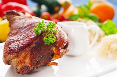 simsearch:400-04684204,k - original German BBQ pork  knuckle served with mashed potatoes and  sauerkraut ,fresh vegetables on background Photographie de stock - Aubaine LD & Abonnement, Code: 400-05384899