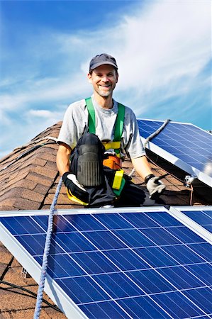 solar panel home - Man installing alternative energy photovoltaic solar panels on roof Stock Photo - Budget Royalty-Free & Subscription, Code: 400-05386108