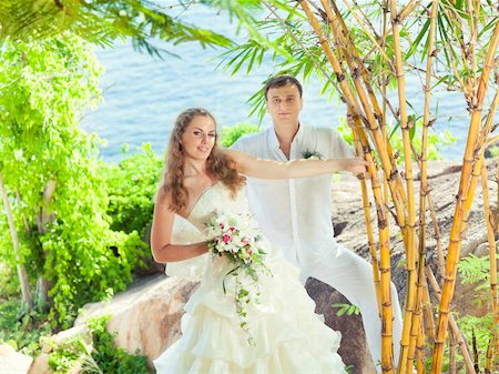 simsearch:400-05328142,k - Bride and groom on the beach. Tropical wedding Stock Photo - Budget Royalty-Free & Subscription, Code: 400-05386298