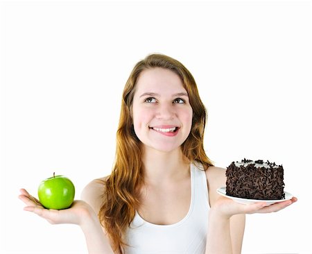 simsearch:400-05106591,k - Tempted young woman holding apple and chocolate cake making a choice Stock Photo - Budget Royalty-Free & Subscription, Code: 400-05383438