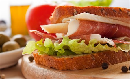 simsearch:400-06207145,k - Prosciutto and cheese sandwich with olives and lettuce. Stock Photo - Budget Royalty-Free & Subscription, Code: 400-05666517