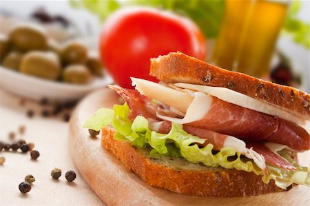 simsearch:400-06207145,k - Prosciutto and cheese sandwich with olives and lettuce. Stock Photo - Budget Royalty-Free & Subscription, Code: 400-05666518