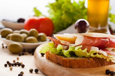 simsearch:400-06207145,k - Prosciutto and cheese sandwich with olives and lettuce.Focus is on the cheese. Shallow depth of field. Stock Photo - Budget Royalty-Free & Subscription, Code: 400-05666519