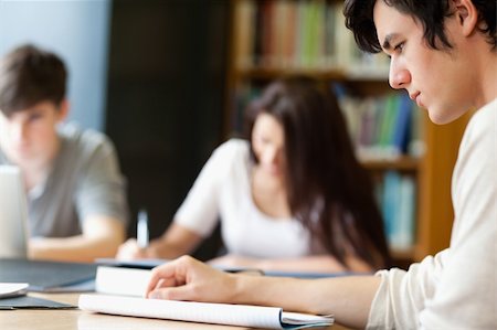 simsearch:400-05669755,k - Students working on a paper with the camera focus on the foreground Photographie de stock - Aubaine LD & Abonnement, Code: 400-05668904