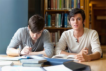 simsearch:400-05669755,k - Handsome student reviewing their notes in a library Photographie de stock - Aubaine LD & Abonnement, Code: 400-05668929