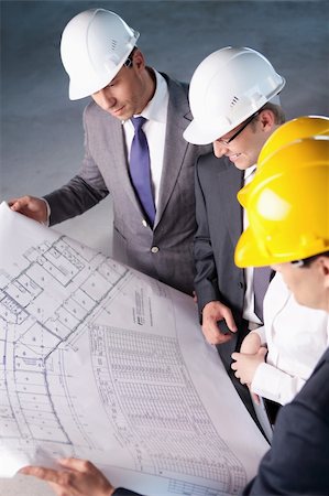 People in hard hats looking plan Stock Photo - Budget Royalty-Free & Subscription, Code: 400-05669052
