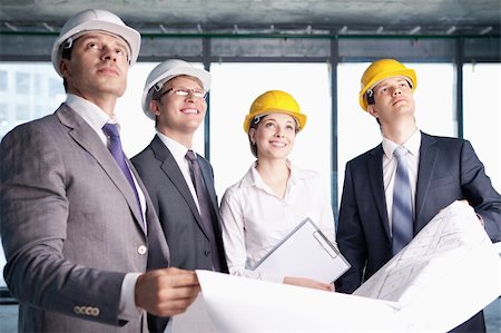 Business people in hard hats looking up at the site Stock Photo - Budget Royalty-Free & Subscription, Code: 400-05669053