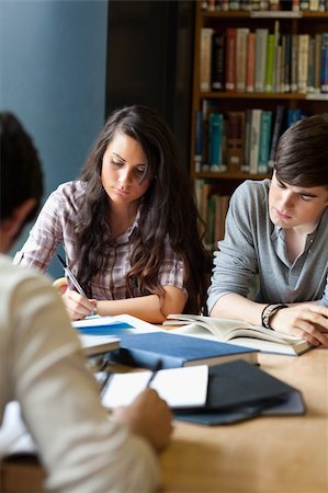 simsearch:400-05669803,k - Portrait of students reviewing for the examinations in a library Stock Photo - Budget Royalty-Free & Subscription, Code: 400-05669755