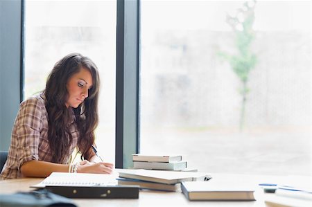 Beautiful student writing an essay in a library Stock Photo - Budget Royalty-Free & Subscription, Code: 400-05669765