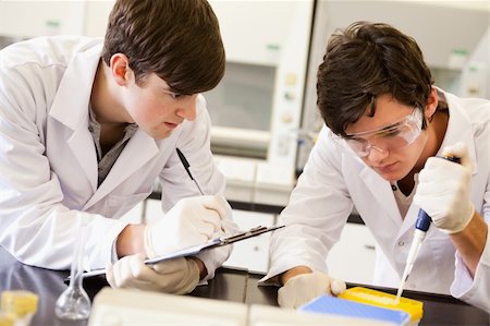 Male scientists making an experiment in a laboratory Stock Photo - Budget Royalty-Free & Subscription, Code: 400-05669779