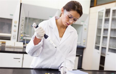 simsearch:400-04881594,k - Serious scientist pouring a liquid in an Erlenmeyer flask in a laboratory Stock Photo - Budget Royalty-Free & Subscription, Code: 400-05669821