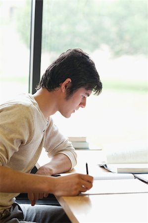 simsearch:400-05669803,k - Serious student reviewing for an assignment in a library Stock Photo - Budget Royalty-Free & Subscription, Code: 400-05669848
