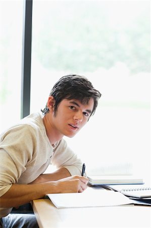 simsearch:400-05669803,k - Portrait of a young student working on an essay in a library Stock Photo - Budget Royalty-Free & Subscription, Code: 400-05669888