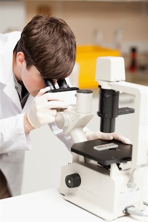 simsearch:400-05669968,k - Scientist looking in a microscope in a laboratory Stock Photo - Budget Royalty-Free & Subscription, Code: 400-05669947