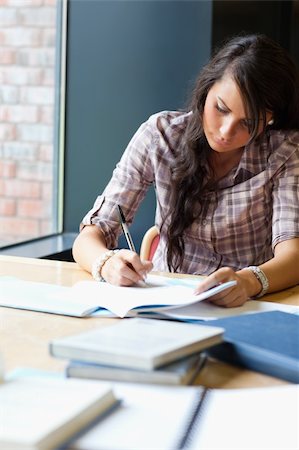 simsearch:400-05669803,k - Portrait of a beautiful student writing an essay in a library Stock Photo - Budget Royalty-Free & Subscription, Code: 400-05669950