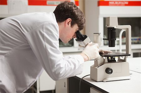 simsearch:400-05669968,k - Young science student looking in a microscope in a laboratory Stock Photo - Budget Royalty-Free & Subscription, Code: 400-05669952